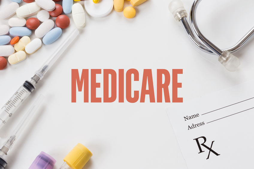 Photograph of Medicare showing some medication pills, stethoscope, syringes and prescription