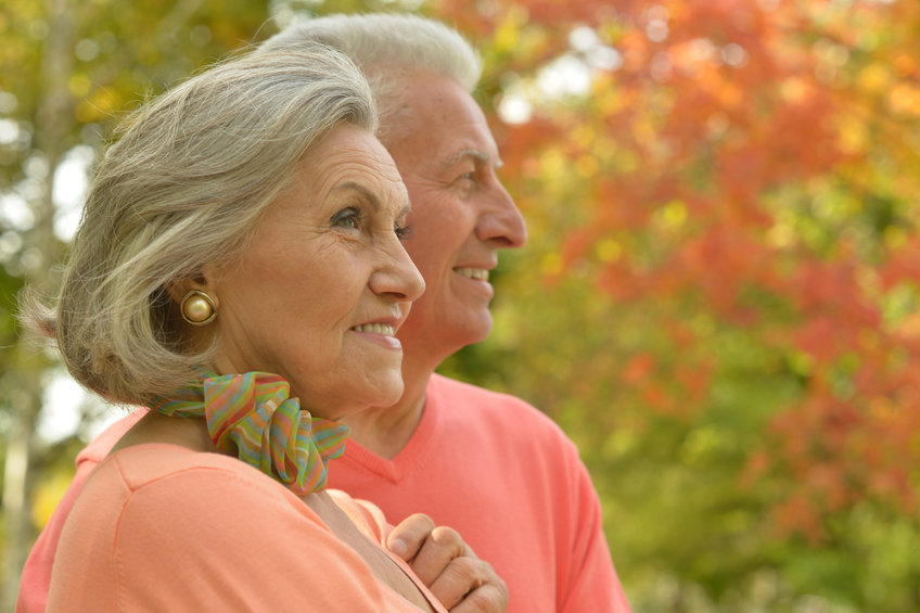 Image of a couple with a fall color background depicting october as long term care planning month
