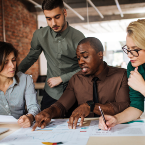 employees surrounding a desk