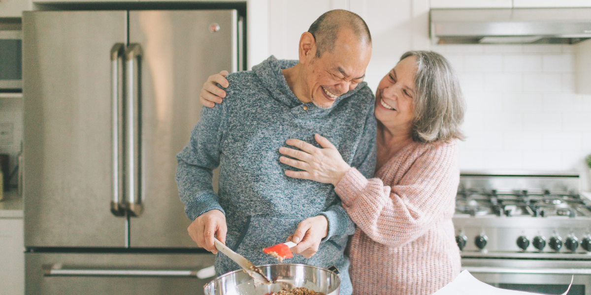 elderly couple in the kitchen cooking