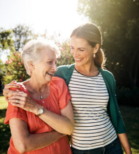 Shot of a young woman going for a walk with her elderly mother in the garden