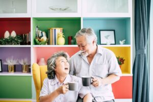senior couple smiling while drinking coffee