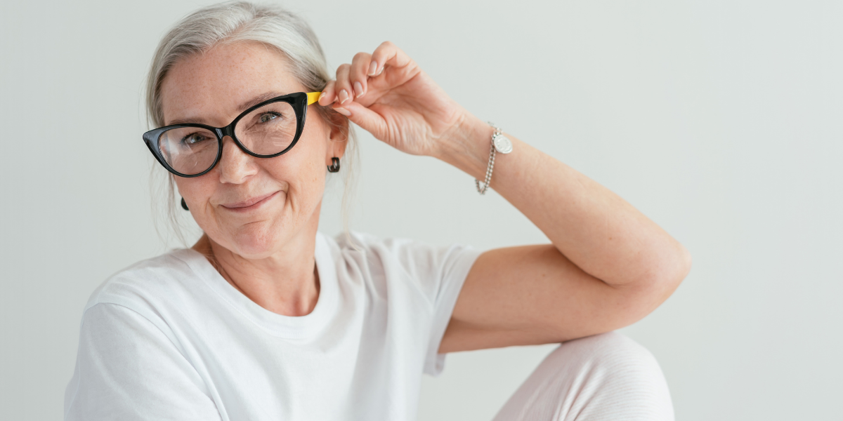 elderly woman with glasses smiling