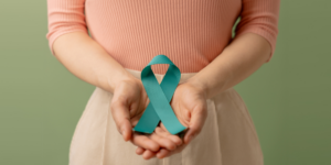 woman holding the cervical cancer ribbon